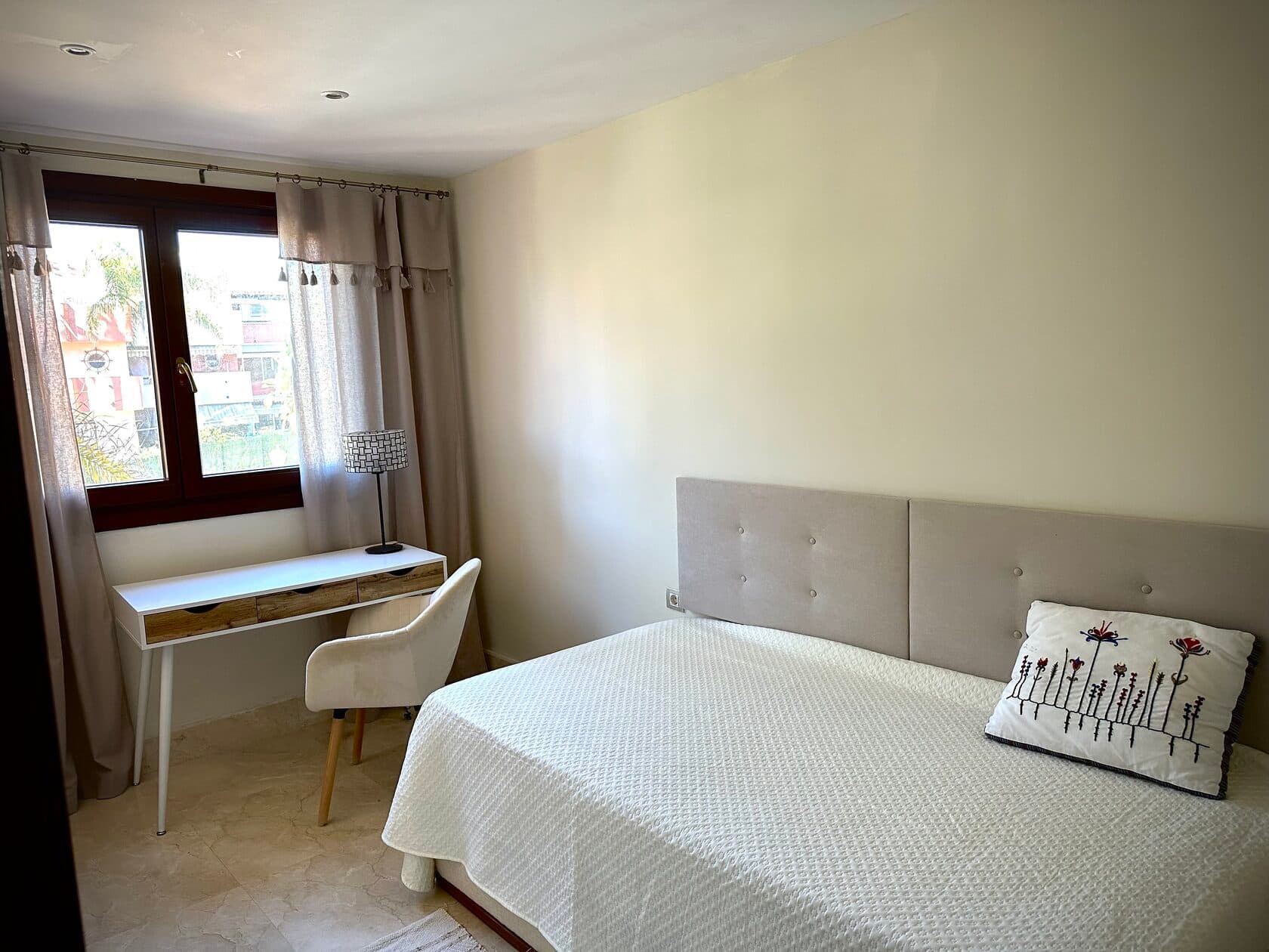 Single bedroom with desk and window